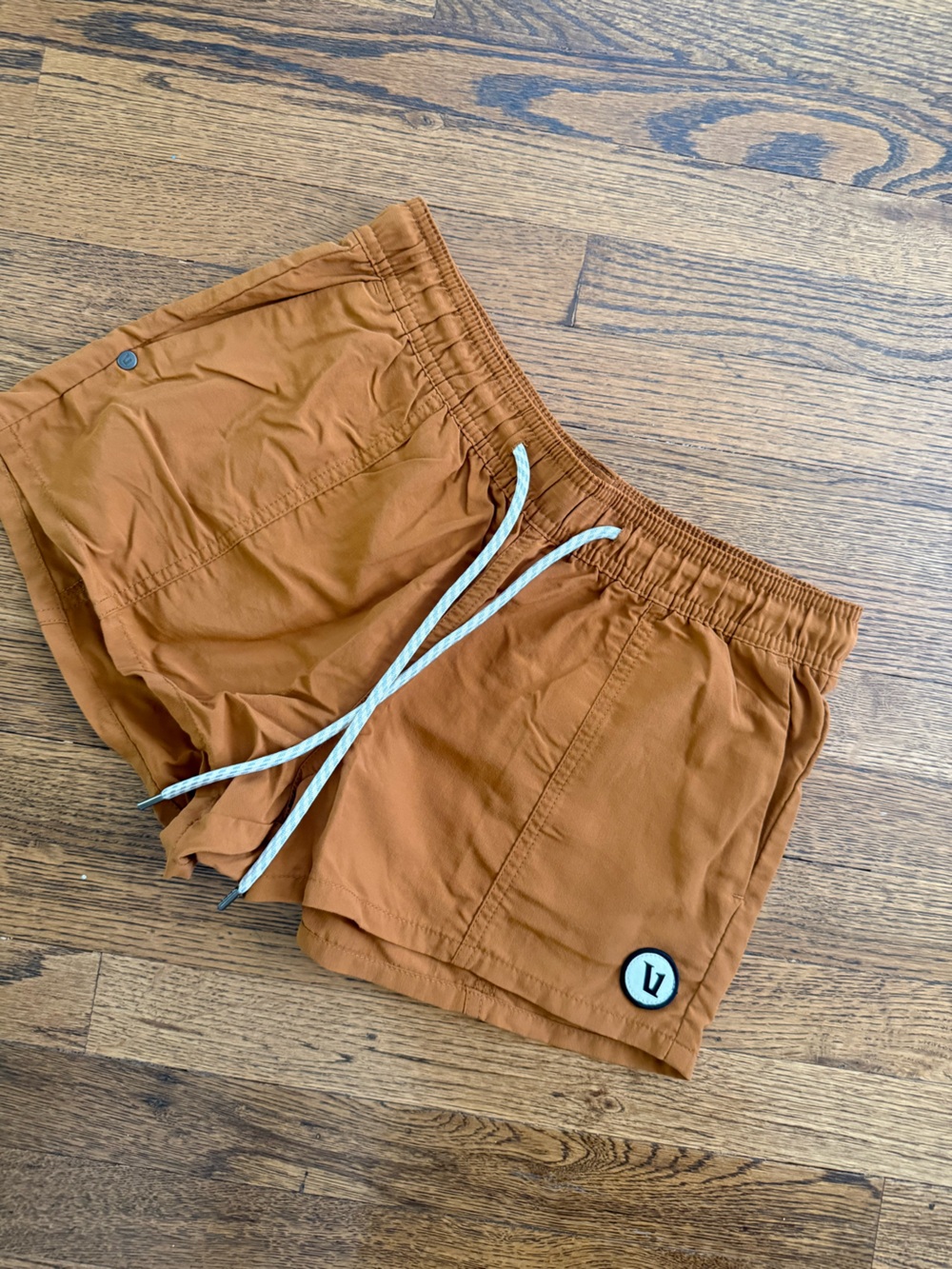 Vuori Women's Athletic Shorts in Rust with White Drawstring